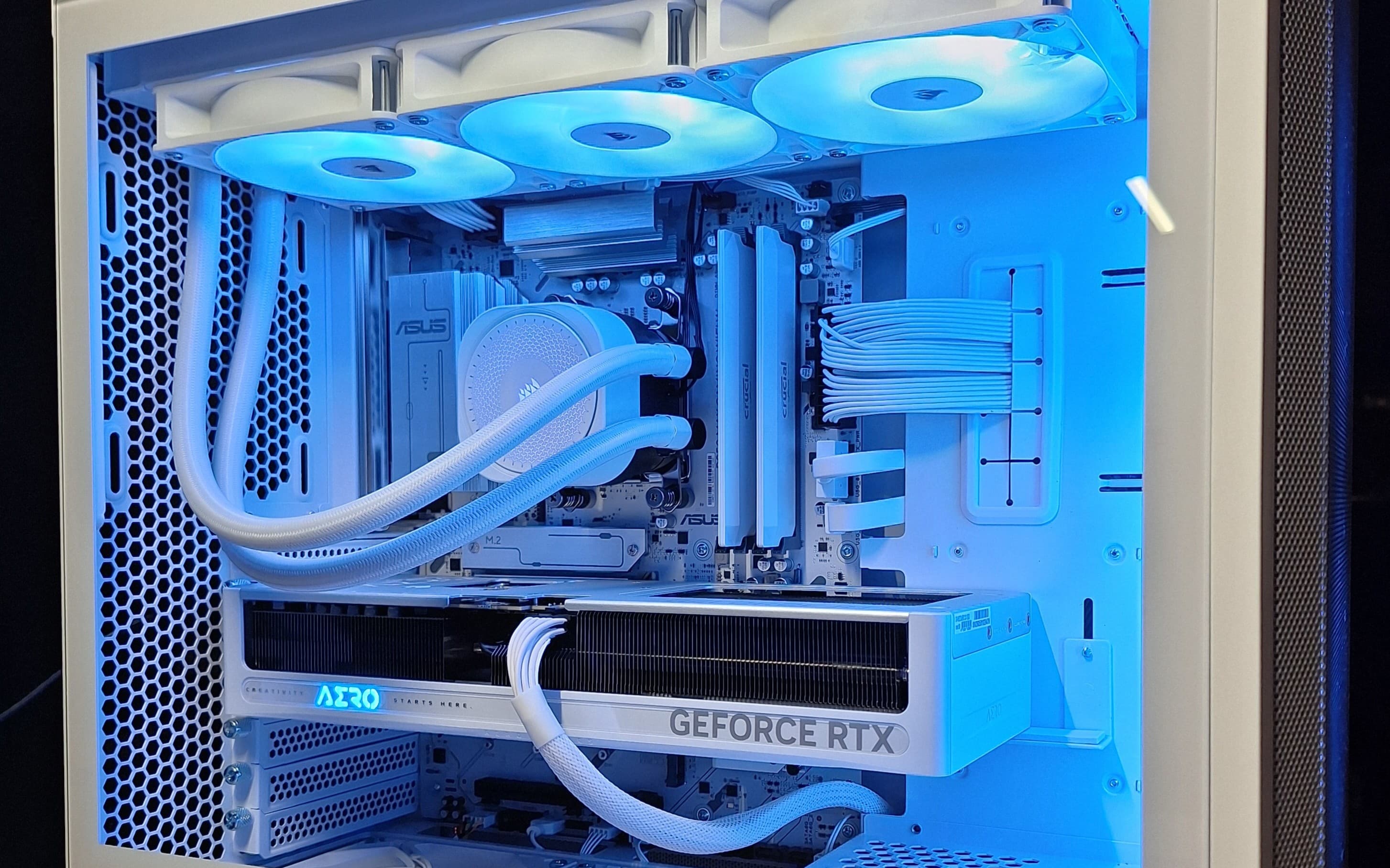 White Lancool 207 gaming PC interior with blue lighting and a GeForce RTX graphics card